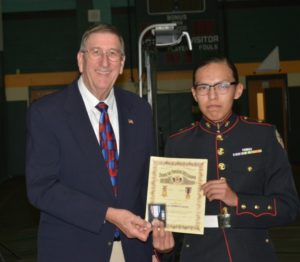 David Swanson presenting a JROTC medal and certificate to Cadet Keith Davis 