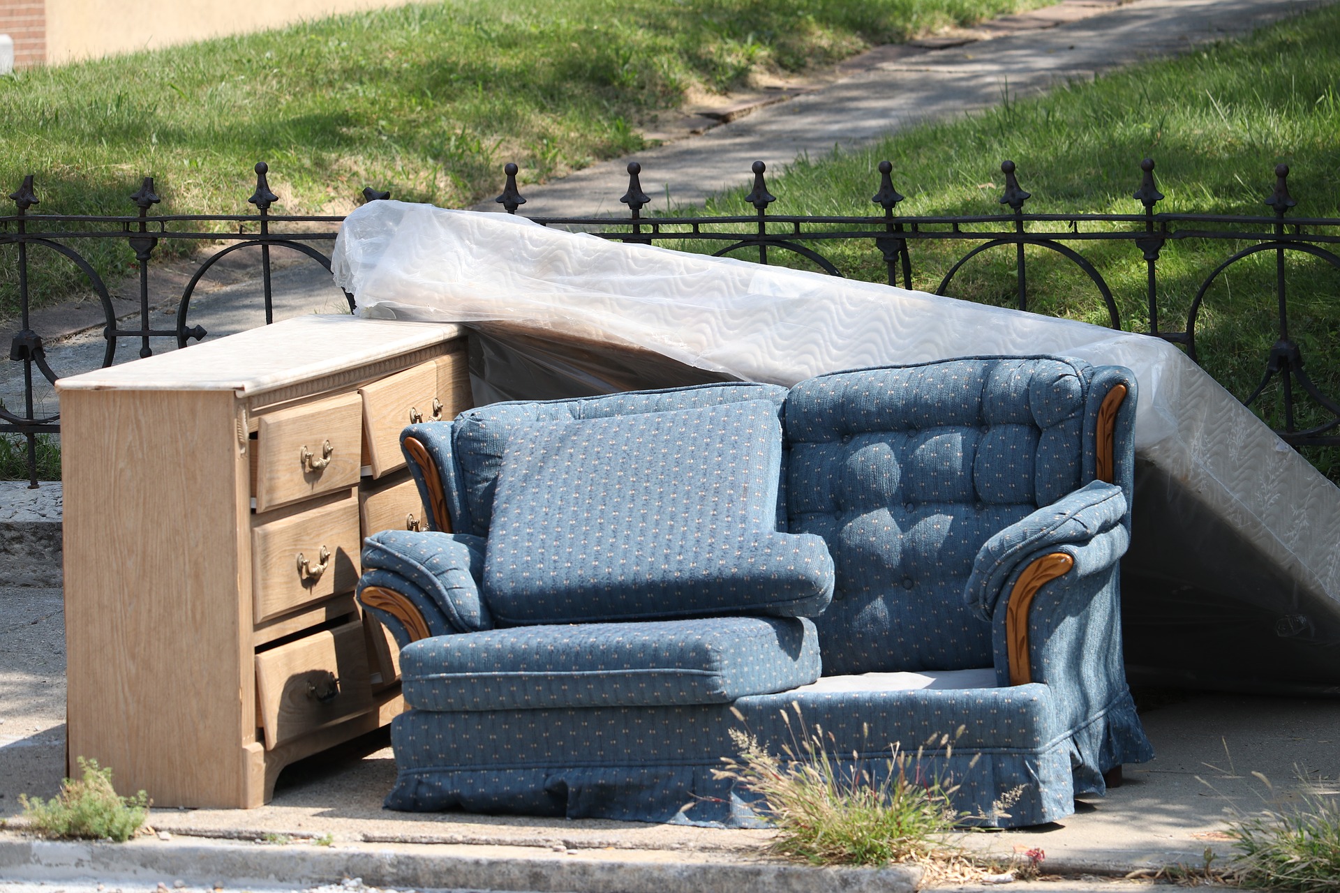 Couch, dresser and box springs on curb for trash picup