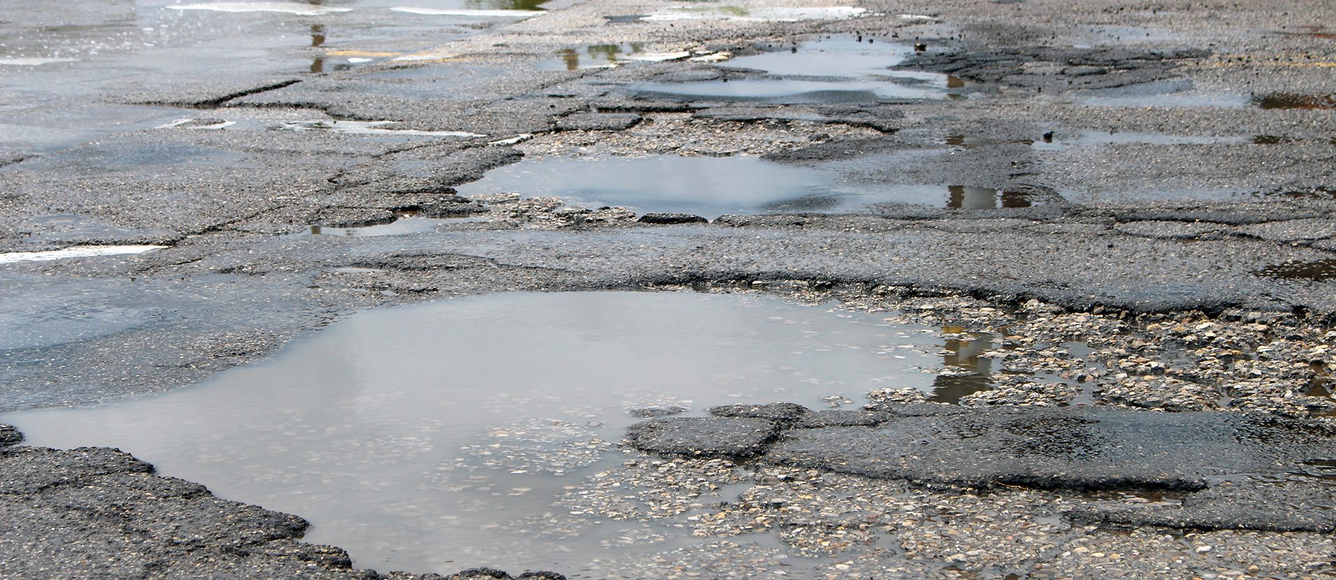 Pot holes with water on Main Street in Lovington, NM