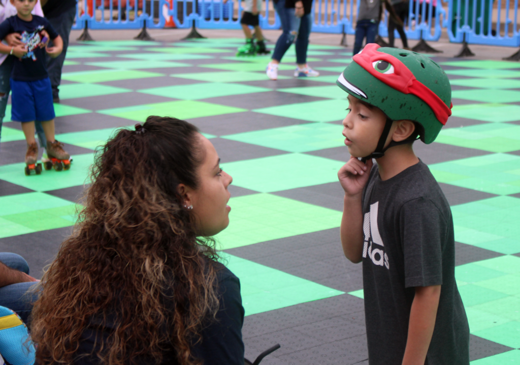 Little boy wearing Raphael TMNT helmet