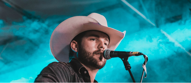 Justin Kemp singing into microphone