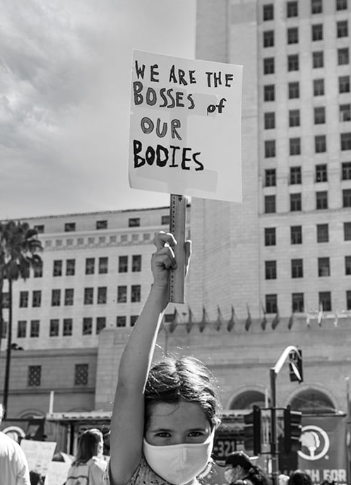 "We are the Bosses of Our Bodies" girl with protest sign